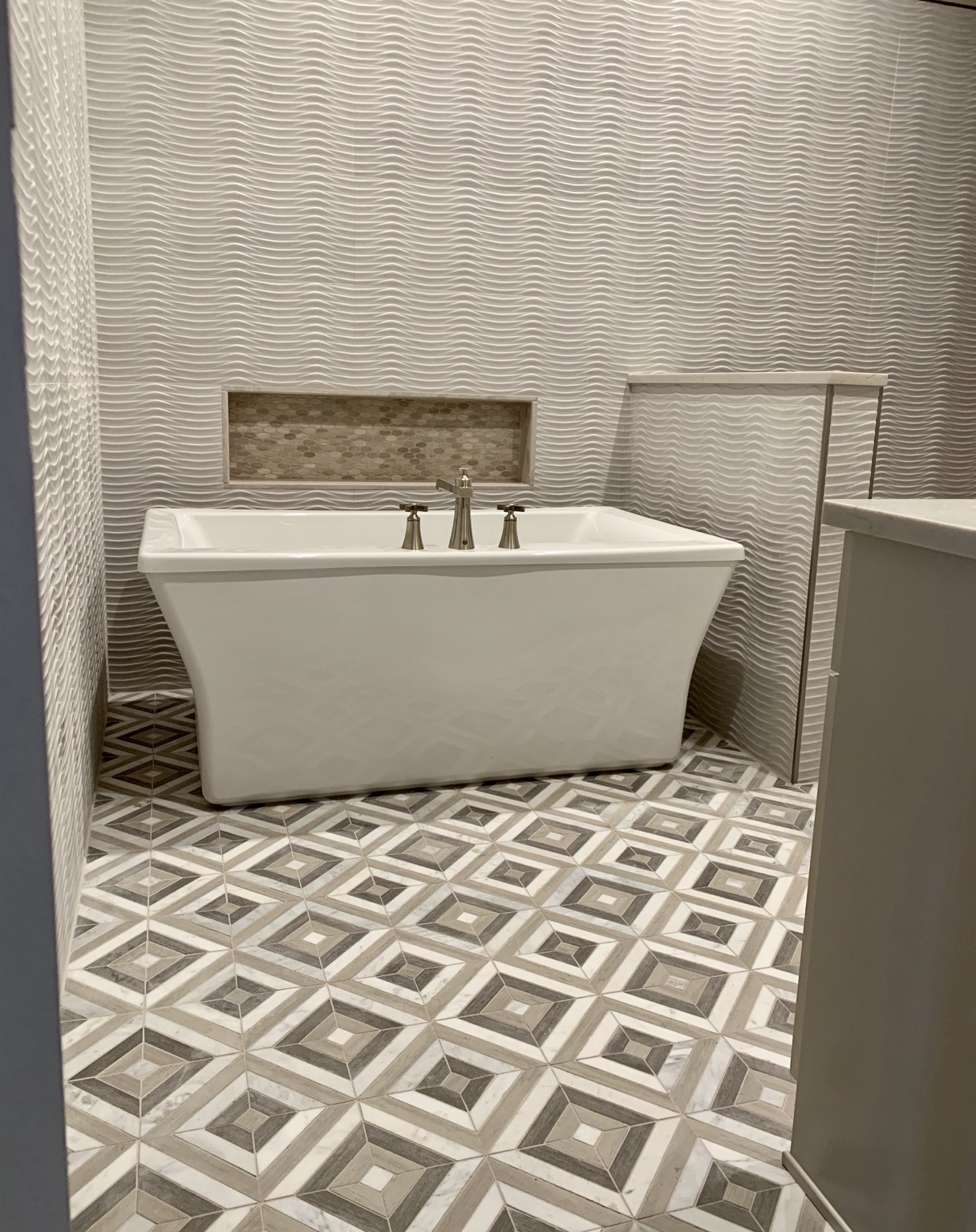 Custom bathroom with freestanding tub and patterned tile