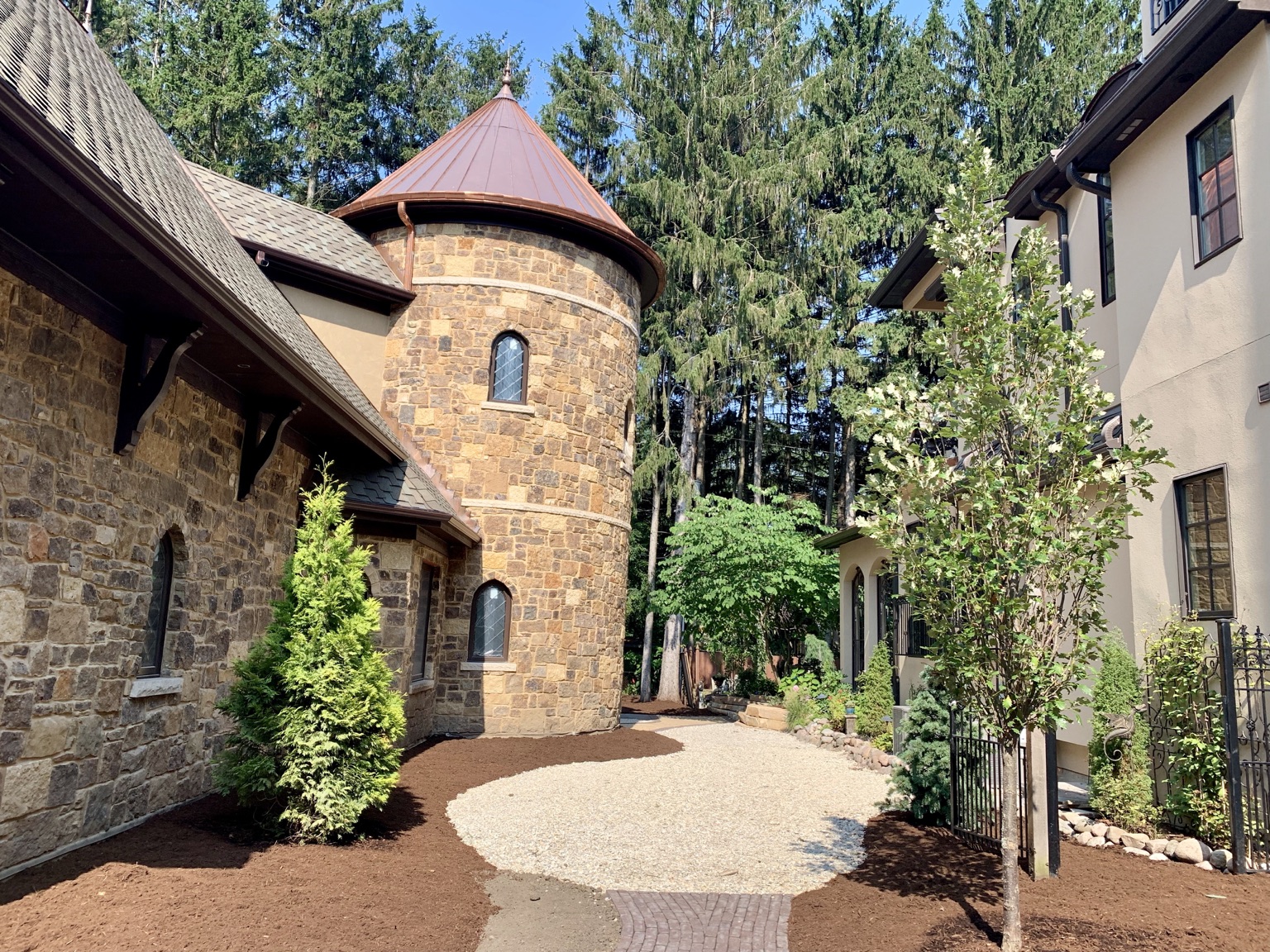 Stone-clad turret and landscaped courtyard at a custom Naperville residence.