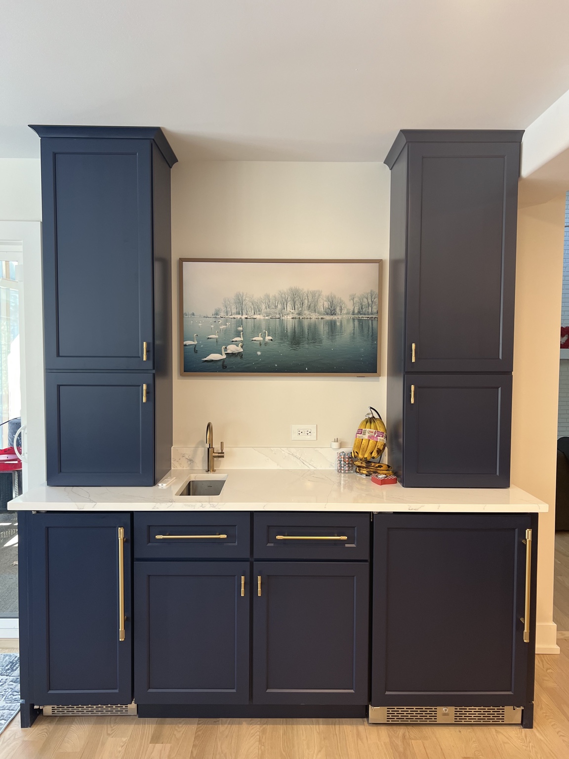 Custom navy beverage center with brass hardware