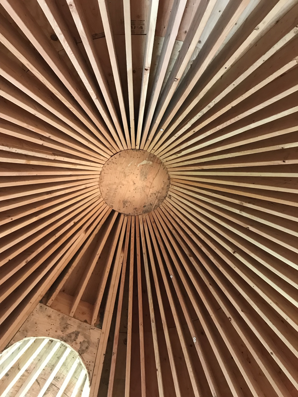 Radial roof framing during construction of the custom stone turret.